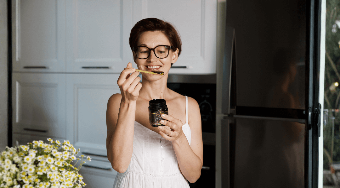 Woman enjoying a spoonful of Manuka honey as part of her daily rituals
