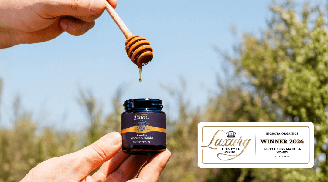 Biosota's Manuka honey winning the Luxury Lifestyle Award 2026 with honey dipper and jar in nature.