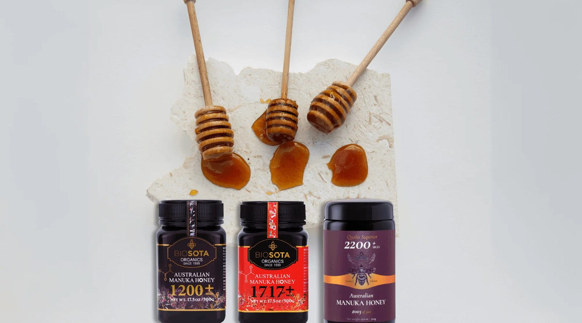 Honey dippers above Biosota Australian Manuka honey jars in MGO 1200+, 1717+ and 2200+